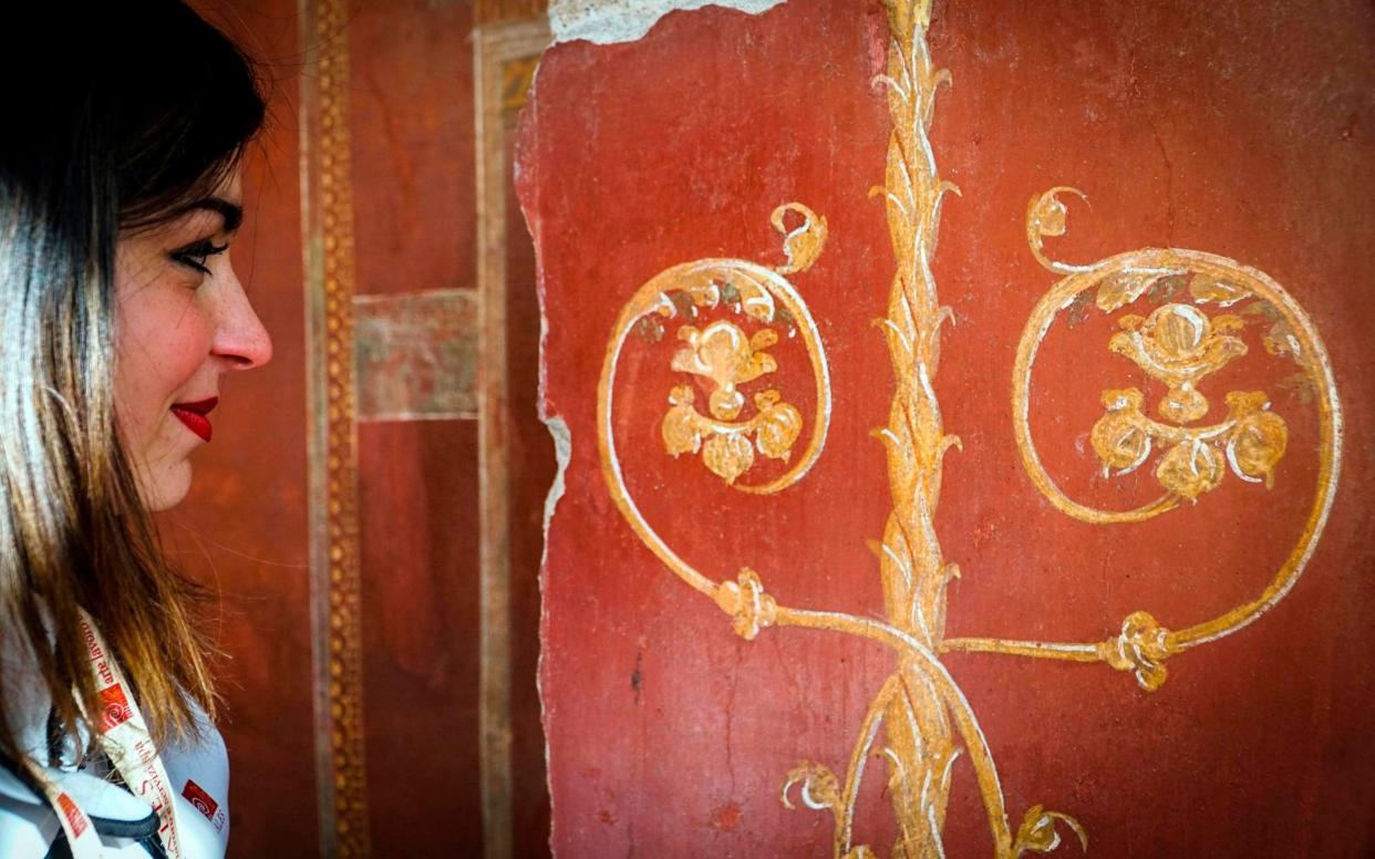 A woman looks at a fresco in the Schola Armaturarum building in Pompeii, a 2,000-year-old building where gladiators trained - ANSA