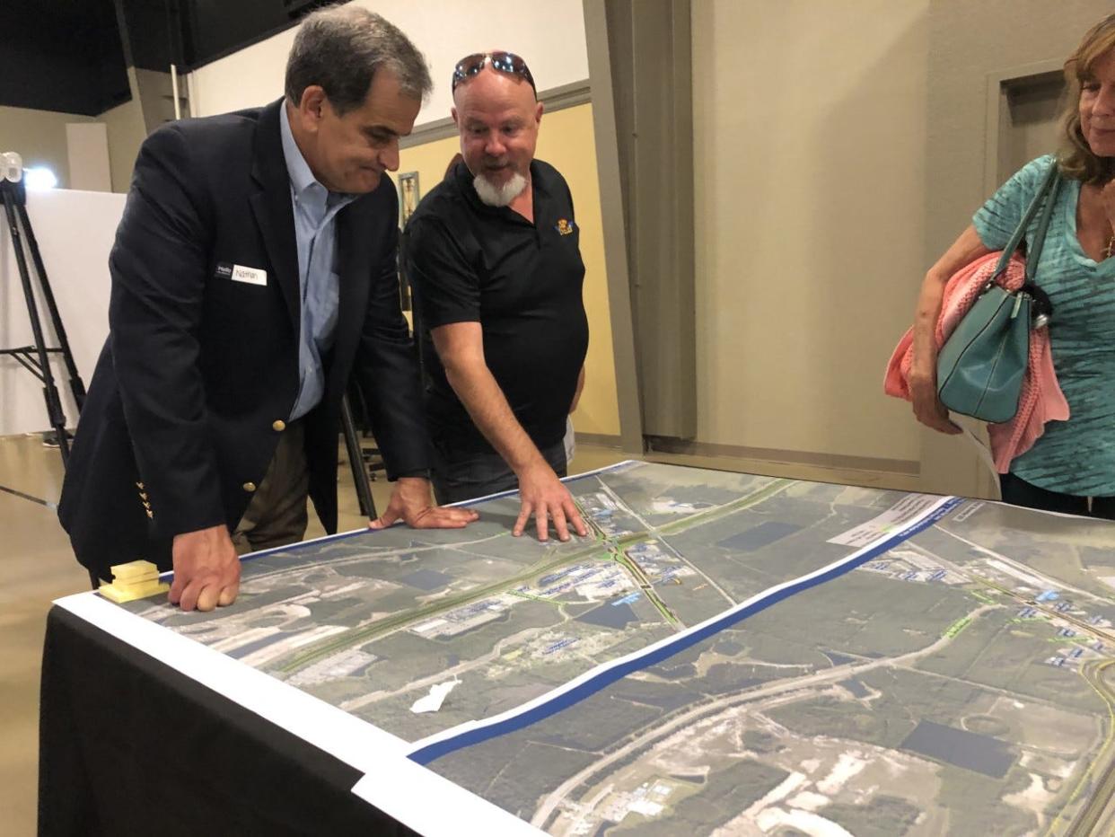 Ormond Beach resident John Crotts, right, offers his opinions on a proposed new interchange at Interstate 95 and U.S. 1 to professional engineer Nathan Silva, project manager with RS&H, a consultant for the Florida Department of Transportation, during a public hearing on Tuesday, June 21, 2022. The FDOT is seeking public comments on two proposed redesign options.