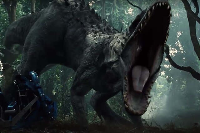 An Indominus Rex roars in the forest in the Jurassic Park film series.