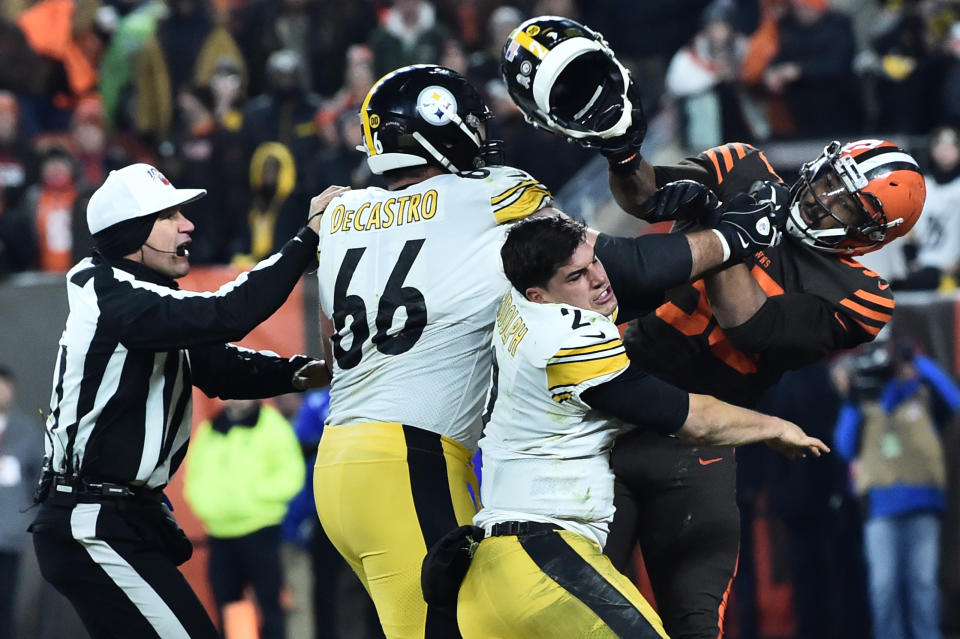 Nov 14, 2019; Cleveland, OH, USA; Cleveland Browns defensive end Myles Garrett (95) hits Pittsburgh Steelers quarterback Mason Rudolph (2) with his own helmet as offensive guard David DeCastro (66) tries to stop Garrett during the fourth quarter at FirstEnergy Stadium. Mandatory Credit: Ken Blaze-USA TODAY Sports