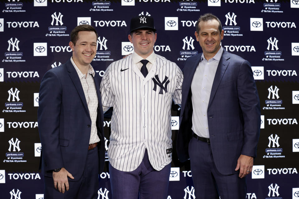 New York Yankees' Carlos Rodon, center, poses for a photo with manager Aaron Boone and pitching coach Matt Blake, left, during his introductory baseball news conference at Yankee Stadium, Thursday, Dec. 22, 2022, in New York. (AP Photo/Adam Hunger)