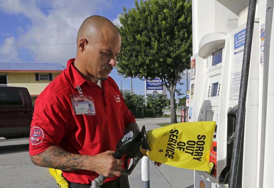 <p>Gas station employee Albert Fernandez covers a pump after running out of gas as the demand for gas has increased due to Hurricane Irma, Wednesday, Sept. 6, 2017, in Key Largo, Fla. (Photo: Alan Diaz/AP) </p>