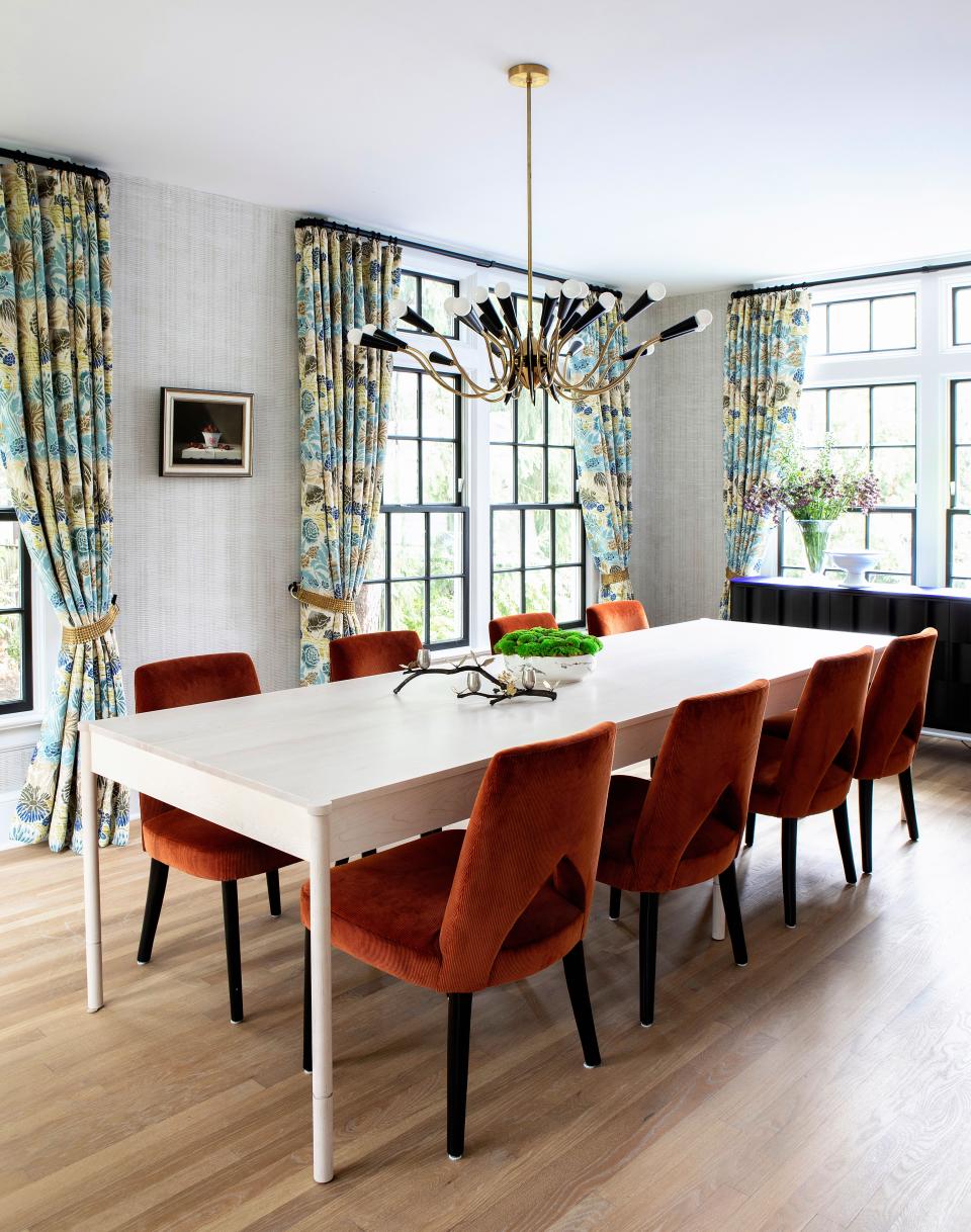 The drapes, by Malhia Kent, add “personality and celebration” to an otherwise minimal and clean dining room, says Galli. The white wooden table is from Egg Collective. The chairs are from The Bright Group, and the amber fabric is by Holland & Sherry. The chandelier is vintage and was sourced from 1stDibs.
