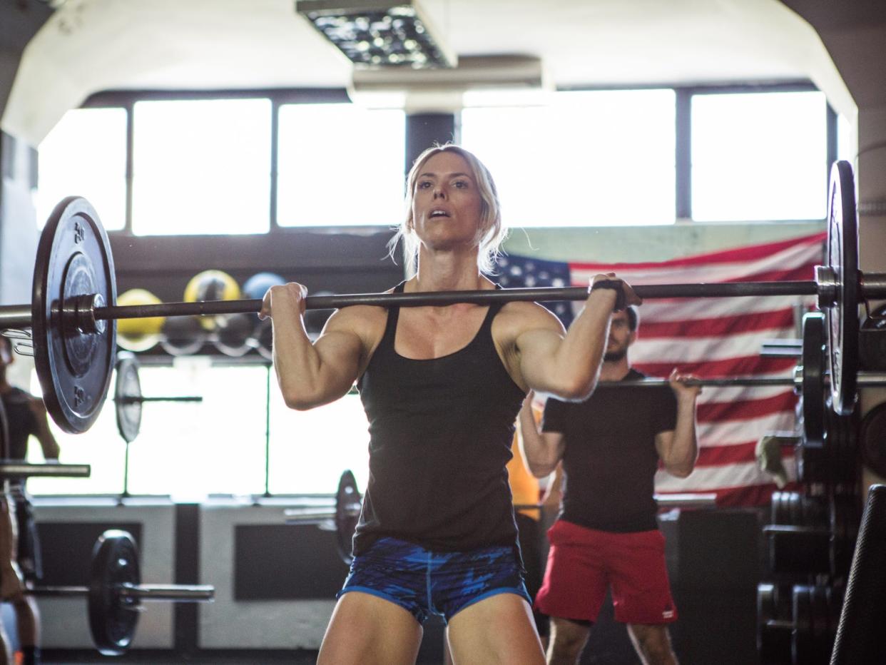 an athlete doing barbell exercise in a gym