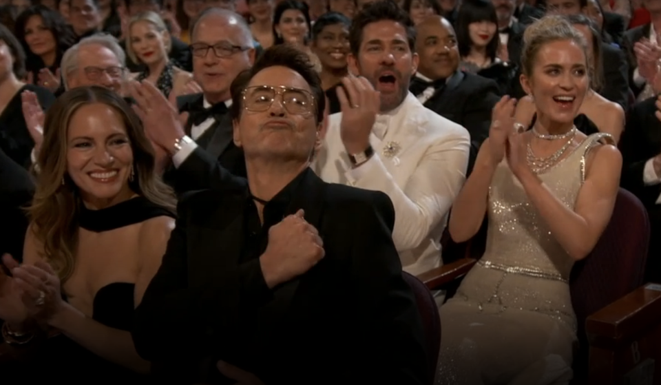 Audience at an event clapping, with various expressions of excitement and applause