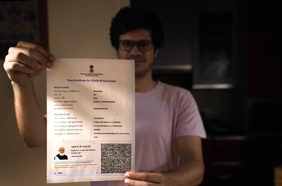 A boy displays his Covishield COVID-19 vaccination certificate in New Delhi, India, Wednesday, Sept. 22, 2021. Travelers and authorities from India and many African countries are furious — and confused — about Britain’s new COVID-19 travel rules, calling them discriminatory. Covishield was added to the U.K.’s list of approved vaccines for travelers on Wednesday, but the group of approved public health bodies remained unchanged — meaning the practical effect of the move is limited. Outrage over Covishield was particularly pointed in India, where the vast majority of people have been vaccinated with the shot. (AP Photo/Manish Swarup)