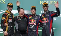 Lotus Formula One driver Romain Grosjean (L-R) of France, Infiniti Red Bull Racing's Head of IT Matt Cadieux, Red Bull Formula One driver Sebastian Vettel of Germany and teammate Mark Webber of Australia pose for pictures on the podium after the Austin F1 Grand Prix at the Circuit of the Americas in Austin November 17, 2013.