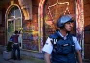 <p>A protester writes on the facade of the Ministry of Justice building during an anti-government protest dubbed “Colorful Revolution,” in Skopje, the former Yogoslav Republic of Macedonia on May 31, 2016. Political crisis hit Macedonia postponed elections due next month, after the European Union called on Skopje to delay the polls to ensure they could take place freely and fairly. The delay was agreed by parliament, which reconvened after Macedonian constitutional court froze all activities related to the controversial parliamentary election, scheduled for July 5 this year. (Georgi Licovski/EPA) </p>