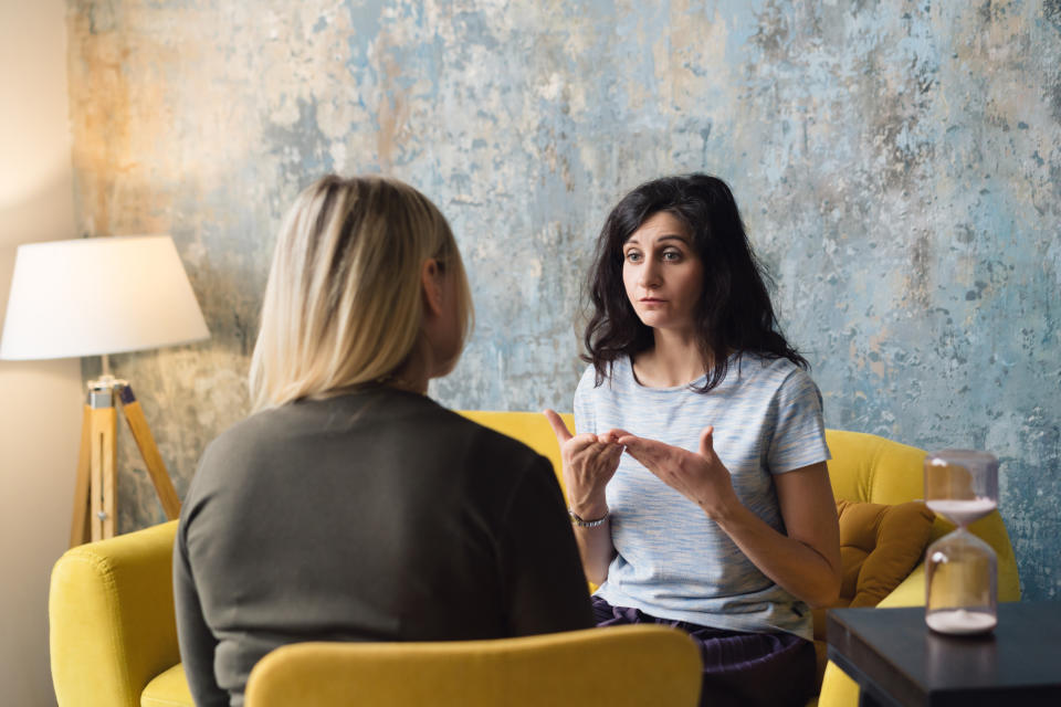 Woman psychologist talking to patient woman. Therapist's gestures. Female talking in coworking office