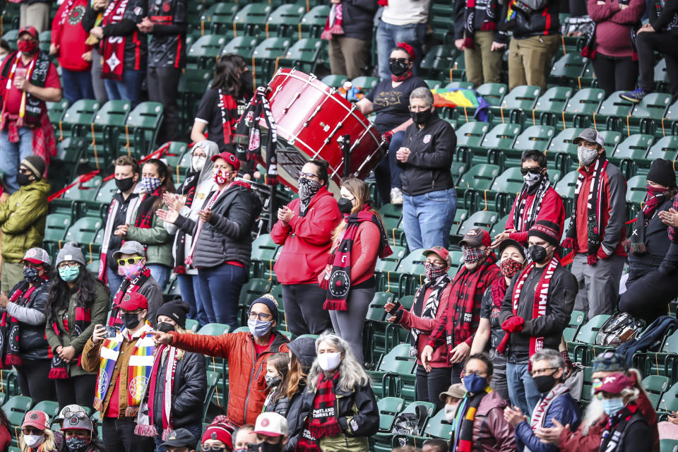 Fans cheer on the Portland Thorns during the second half of the NWSL Challenge Cup soccer final against NJ/NY Gotham FC at Providence Park, Saturday, May 8, 2021, in Portland, Ore. (Serena Morones/The Oregonian via AP)