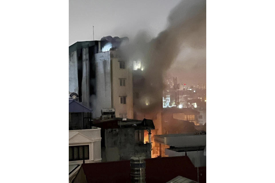 Smoke rises from a building in Hanoi, Vietnam Wednesday, Sept. 13, 2023. Authorities said "many" people had been killed after a fire broke out in the apartment block. (Nhan Huu Sang/VNA via AP)