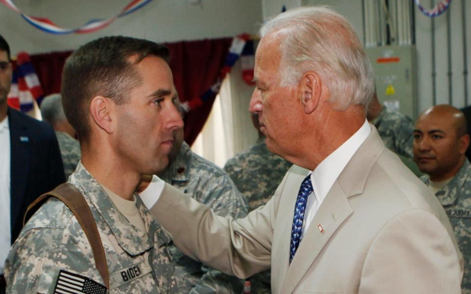 Joe Biden talks with his son Beau Biden at Camp Victory on the outskirts of Baghdad, Iraq in 2009 - Credit: AP