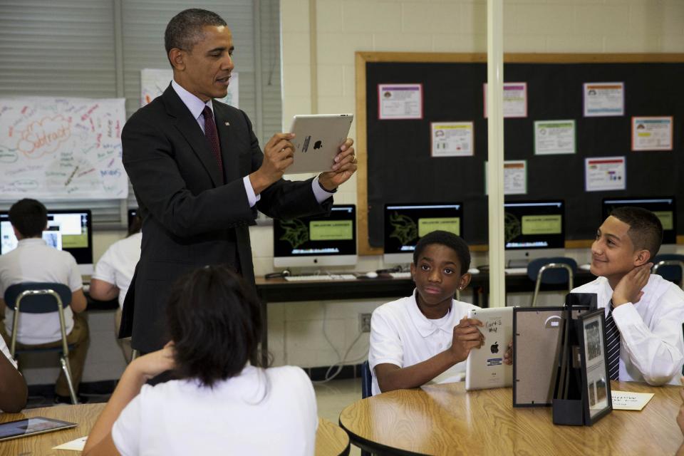 President Barack Obama records students on a classroom iPad while visiting a seventh grade classroom before speaking about goals of connecting students to next generation broadband and wireless technology within five years, Tuesday, Feb. 4, 2014, at Buck Lodge Middle School in Adelphi, Md. (AP Photo/Jacquelyn Martin)