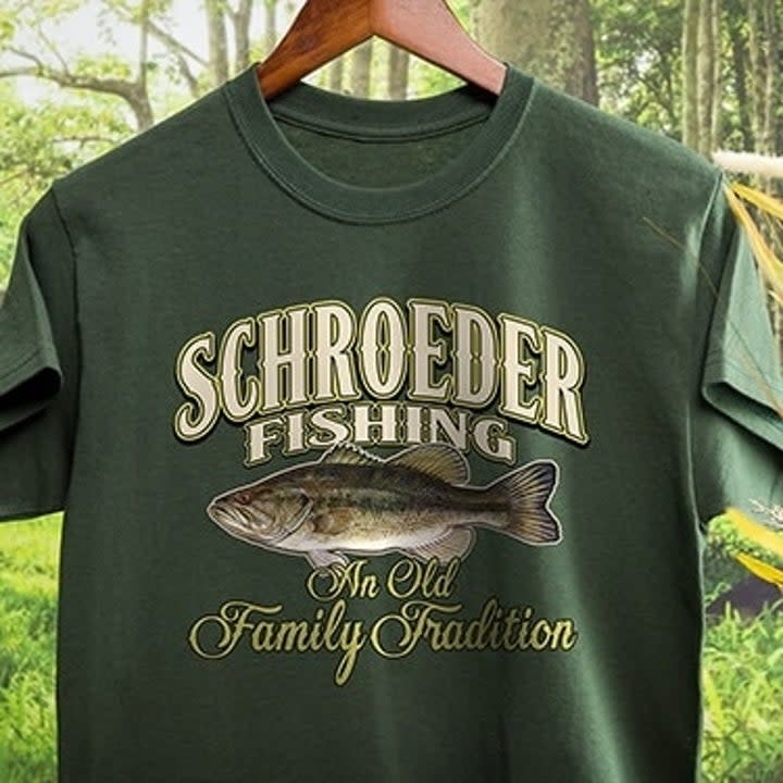 a green shirt featuring a fish print and text reading 