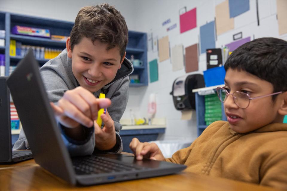 Fourth grade student Juan Ramirez helps Adding Elijah with schoolwork during an aftercare program at Garcia Elementary School on Thursday, March 28, 2024, in Corpus Christi, Texas.