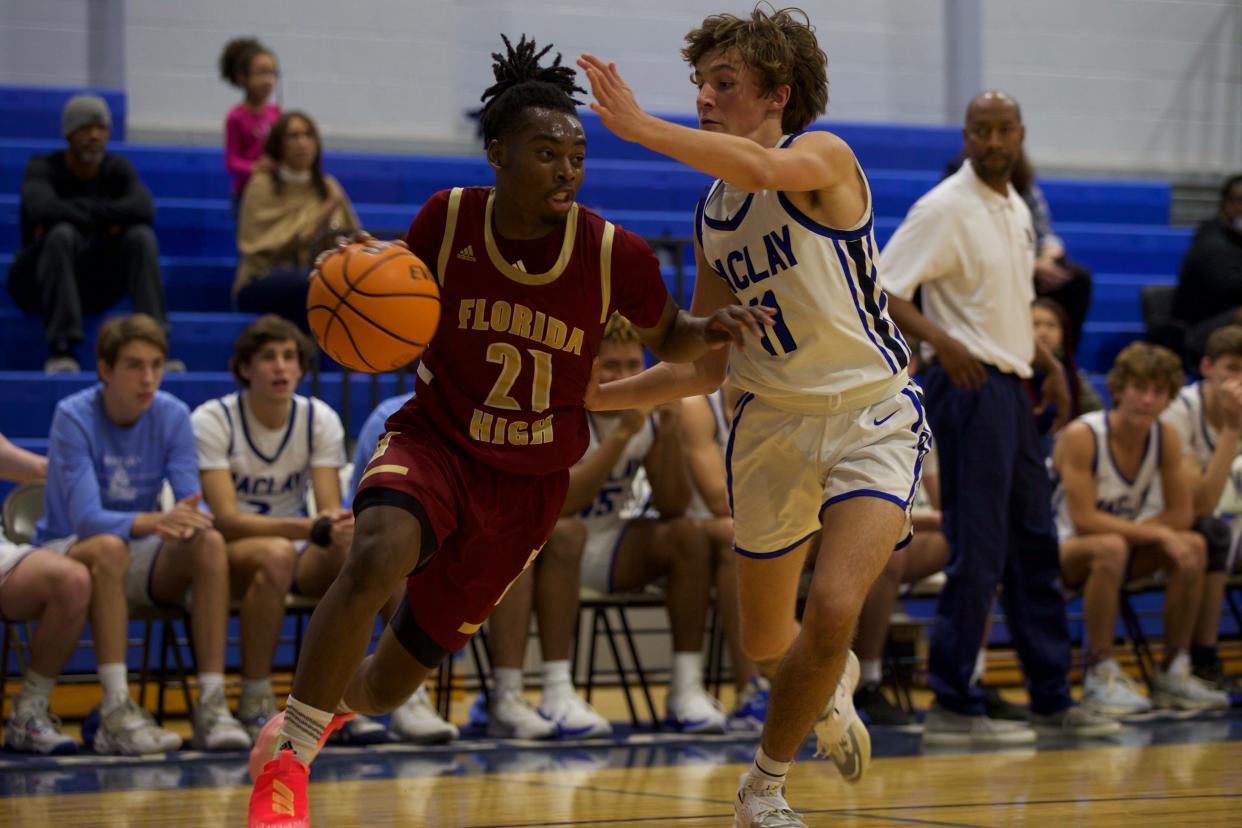 Junior guard Thaddeus Burns (21) battles with a Maclay defender in a game against Maclay on Dec. 9, 2021, at Maclay School. The Seminoles defeated the Marauders, 78-59.