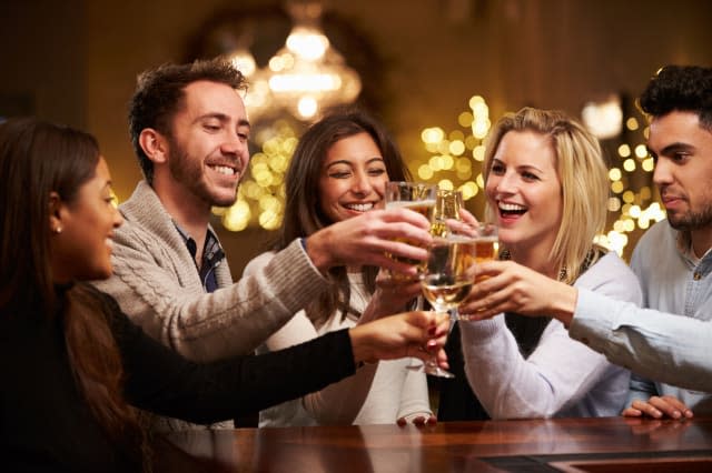 Group Of Friends Enjoying Evening Drinks In Bar