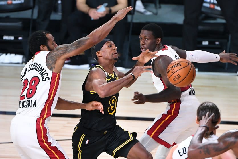 ORLANDO, FLORIDA OCTOBER 2, 2020-Lakers Rajon Rondo has the ball knocked away by Heat's Kendrick Nunn, right, but goes out of bounds as Andre Igoudala helps on defense in the 3rd quarter in Game 2 of the NBA FInals in Orlando Friday. (Wally Skalij/Los Angeles Times)