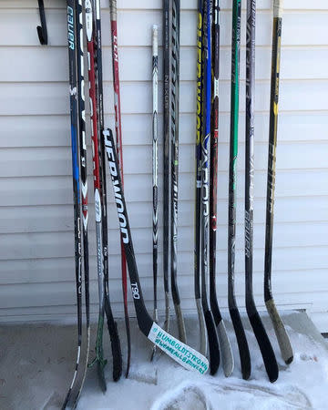 Hockey sticks are seen on a porch in tribute to the 15 youth players and personnel killed in a bus crash, in Portage la Prairie, Manitoba, Canada April 9, 2018 in this picture obtained from social media. INSTAGRAM/@FOURTHKIDPROBLEMS via REUTERS