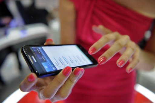 A Huawei Ascend D1 smartphone is on display at the CommunicAsia telecom expo and conference in Singapore in June 2012. Huawei, founded by a former People's Liberation Army engineer, has established itself as a major force in the global telecoms industry where its technology is widely used to build mobile phone networks