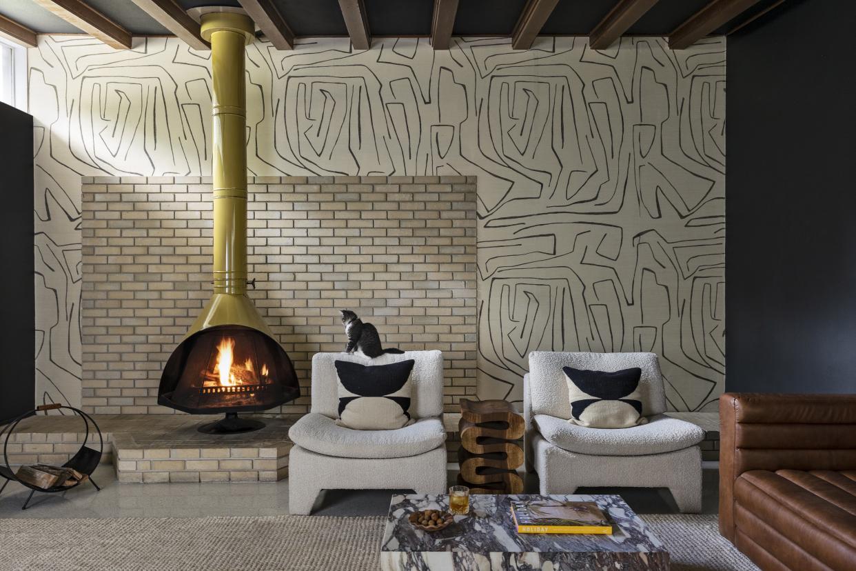  Living room with modern fireplace and statement wallpaper 