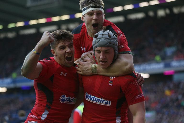 Wales centre Jonathan Davies (R) celebrates with teammate Rhys Webb during their Six Nations match against Scotland in Edinburgh on February 15, 2015