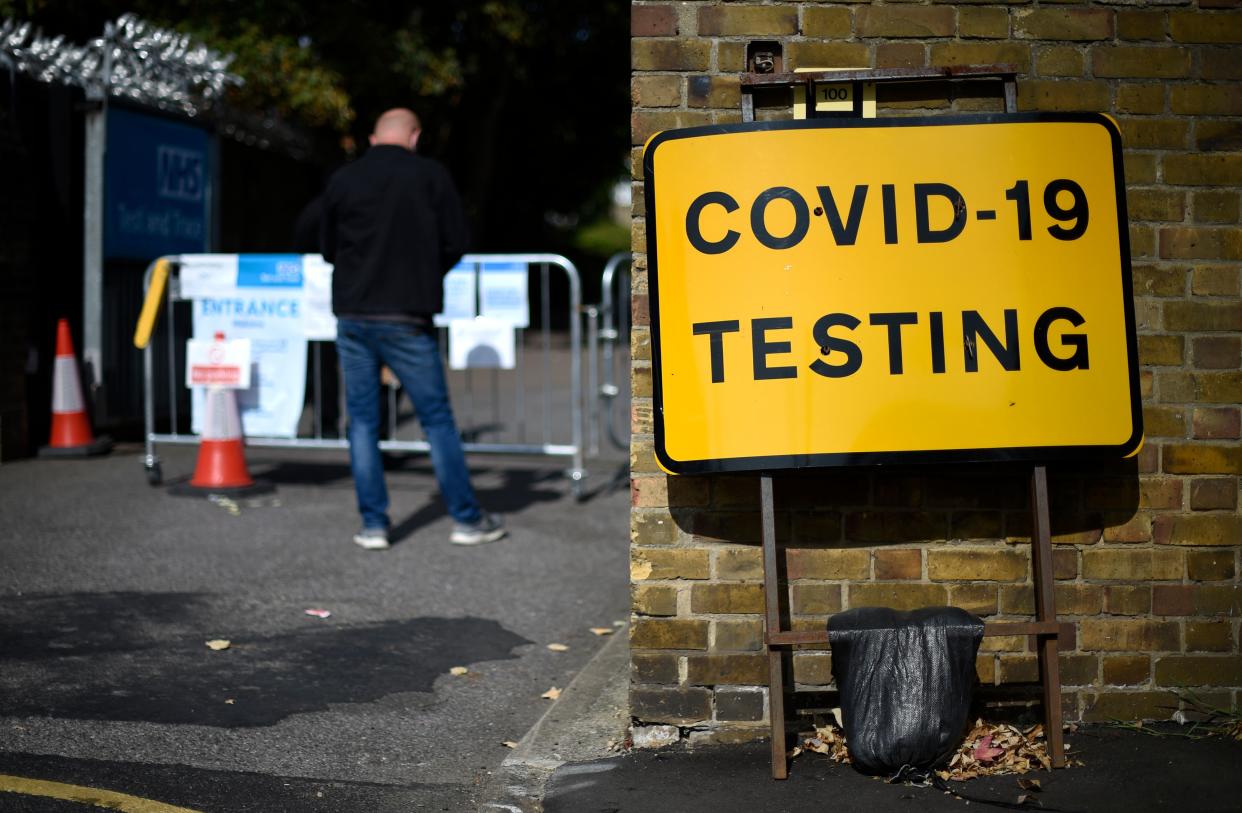 A man wearing a face covering due to the COVID-19 pandemic, queues to attend a novel coronavirus walk-in testing centre in East Ham in east London, on September 17, 2020. - British Prime Minister Boris Johnson said Thursday he could close pubs earlier to "stop the second hump" of coronavirus cases, comparing the country's trajectory of resurgent transmission to a camel's profile. But the prime minister has faced stinging criticism this week over the failure to achieve the "world-beating" testing and tracing system he promised by the summer. (Photo by DANIEL LEAL-OLIVAS / AFP) (Photo by DANIEL LEAL-OLIVAS/AFP via Getty Images)
