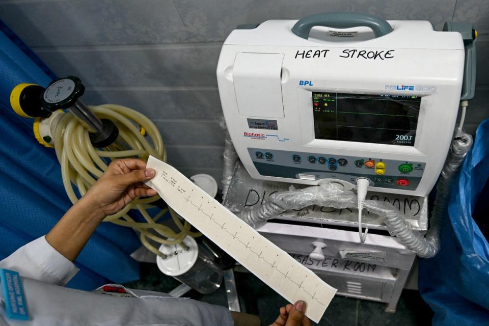 A doctor works with a defibrillator designated for patients suffering heat stroke. One of the first signs of heat-related illness is a rapid heart rate, experts tell The Independent (AFP via Getty Images)