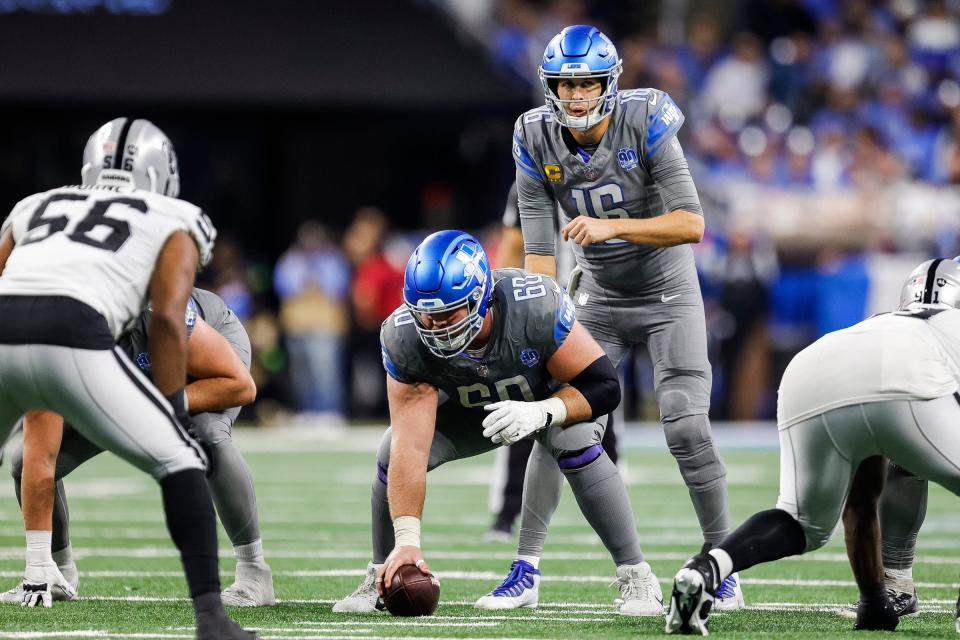 Detroit Lions quarterback Jared Goff (16) talks to guard Graham Glasgow (60) before a snap against Las Vegas Raiders during the second half at Ford Field in Detroit on Monday, Oct. 30, 2023.