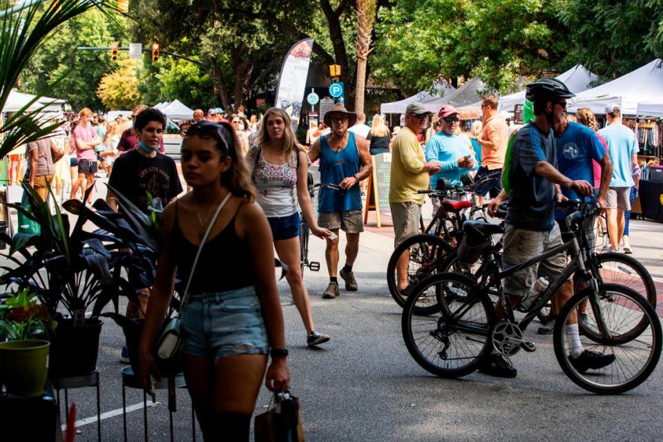 People shop at Soda City Market in downtown Columbia, South Carolina on Saturday, August 21, 2021. The market stretches multiple blocks with vendors from all over South Carolina.