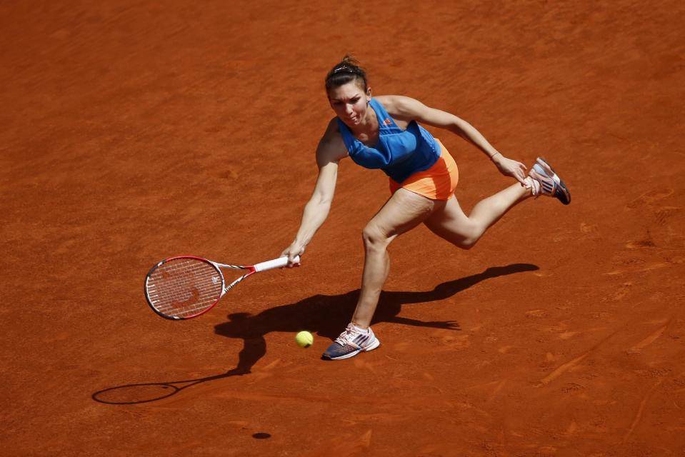 Simona Halep from Romania returns the ball during a Madrid Open tennis tournament match against Petra Kvitova from Czech Republic in Madrid, Spain, Saturday, May 10, 2014. (AP Photo/Daniel Ochoa de Olza)