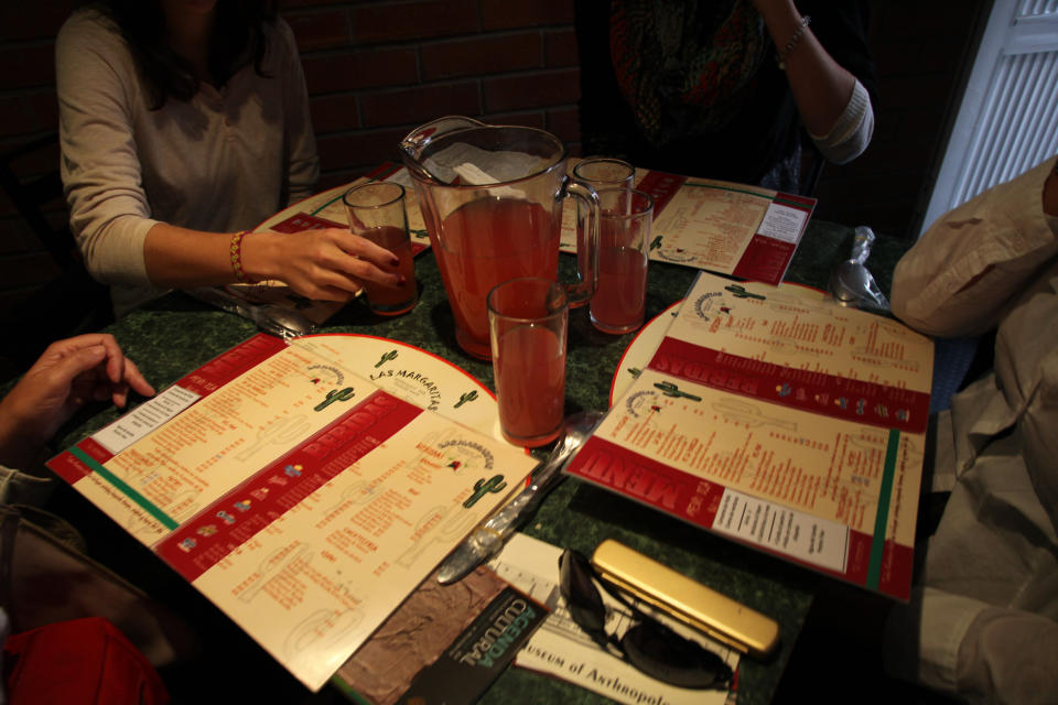 In this Jan. 7, 2014 photo, customers enjoy a pitcher of flavored water at a restaurant in Mexico City. Bad tap water accounts in part for Mexico being the highest consumer of bottled water and sweetened drinks. A law recently approved by Mexico City’s legislators will require all restaurants to install filters, offering patrons free, apparently drinkable potable water that won’t lead to stomach problems and other ailments. With an obesity epidemic looming nationwide, the city’s health department decided to back the water initiative. (AP Photo/Marco Ugarte)