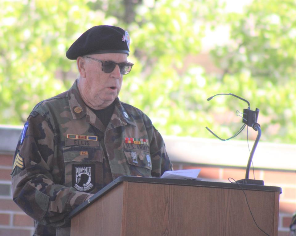 Cheboygan County veteran Greg Ellis reads names in honor and to remember those missing or killed in action during Monday's Memorial Day ceremony at Festival Square in Cheboygan.