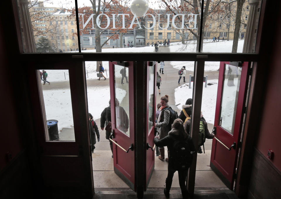 FILE - University of Wisconsin-Madison students leave the Education Building between classes at the public university, Jan. 27, 2015, in Madison, Wis. The Universities of Wisconsin and Assembly Republican Speaker Robin Vos have reached a sweeping deal released Friday, Dec. 8, 2023, that would freeze hiring for diversity positions across the system in exchange for lawmakers approving employee pay raises and funding for a new engineering building at the flagship campus. Vos blocked pay raises and Republicans refused to release money for the engineering building earlier this year. (M.P. King/Wisconsin State Journal via AP, File)