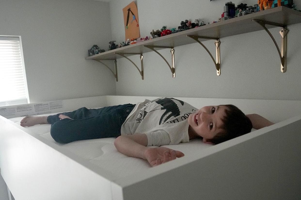 "I really like that I'm getting a new bed," Leon Adamson said. The 8-year-old had been waking up with back pain from a too-stiff mattress.
