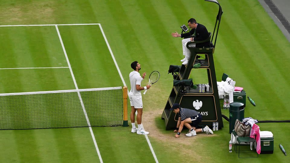 Djokovic argues with the umpire following a point deduction for shouting. - Glyn Kirk/AFP/Getty Images