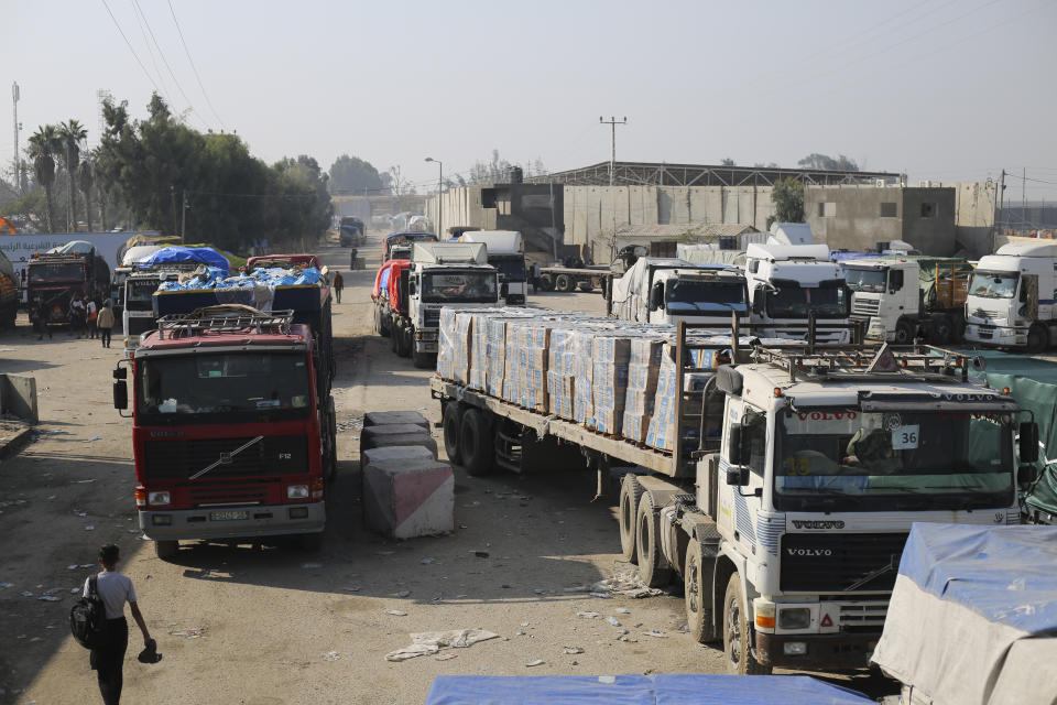 Humanitarian aid trucks enter through the Kerem Shalom crossing from Israel into the Gaza Strip on Monday, Dec. 18, 2023. (AP Photo/Hatem Ali)