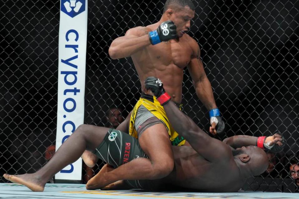 May 13, 2023; Charlotte, North Carolina, USA; Jairzinho Rozenstruik (red gloves) fights Jailton Almeida (blue gloves) in a heavyweight bout during UFC Fight Night at Spectrum Center. Mandatory Credit: Jim Dedmon-USA TODAY Sports