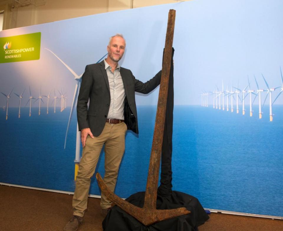 East Anglian Daily Times: Brandon Mason with the unique anchor found during research work for East Anglia ONE