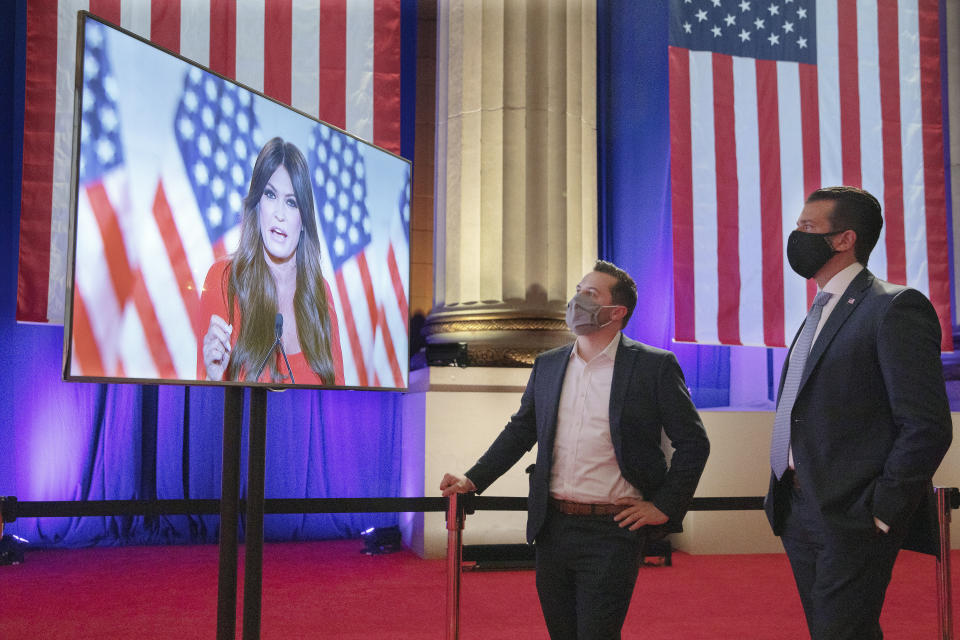 Donald Trump Jr. (right) watches his girlfriend, Kimberly Guilfoyle, a Trump campaign aide, as she records her address for Monday night's Republican National Convention program. (Photo: Chip Somodevilla via Getty Images)