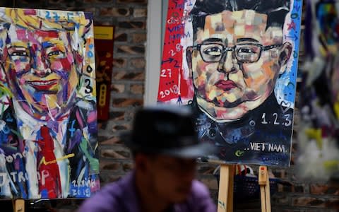 Portraits of Kim and Mr Trump as Hanoi is gripped by summit fever - Credit: Manan Vatsyayana/Reuters