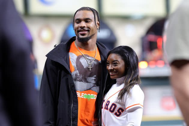 Simone Biles and Jonathan Owens are on the field before Game 1 of the 2022 World Series on October 28, 2022, in Houston, Texas. Recently, Biles posted on social media about their upcoming nuptials.