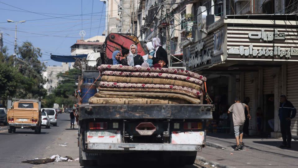 Palestinians with their belongings flee to safer areas in Gaza City after Israeli air strikes on October 13, 2023. - Mohammed Abed/AFP/Getty Images