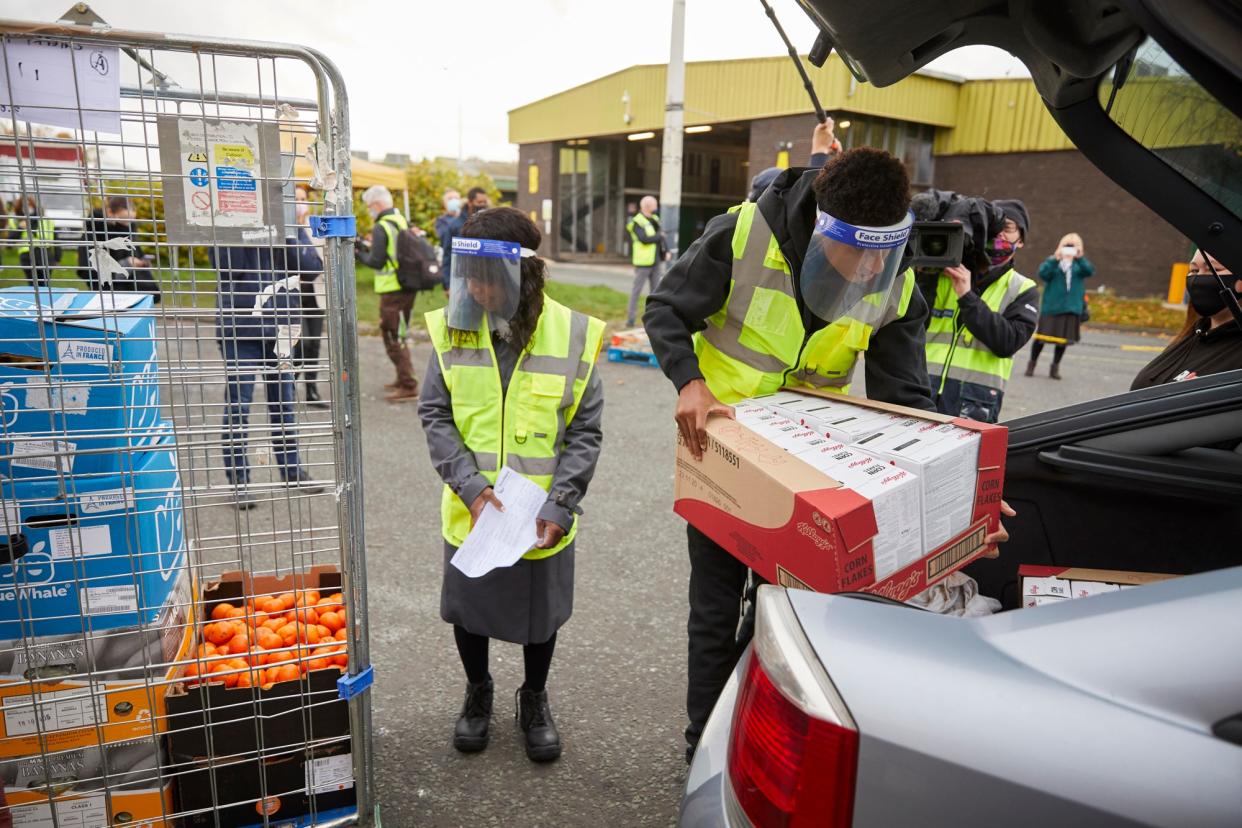 England football star Marcus Rashford visiting FareShare Greater Manchester at New Smithfield Market with his mother (left) (Fareshare/Mark Waugh/PA Wire)