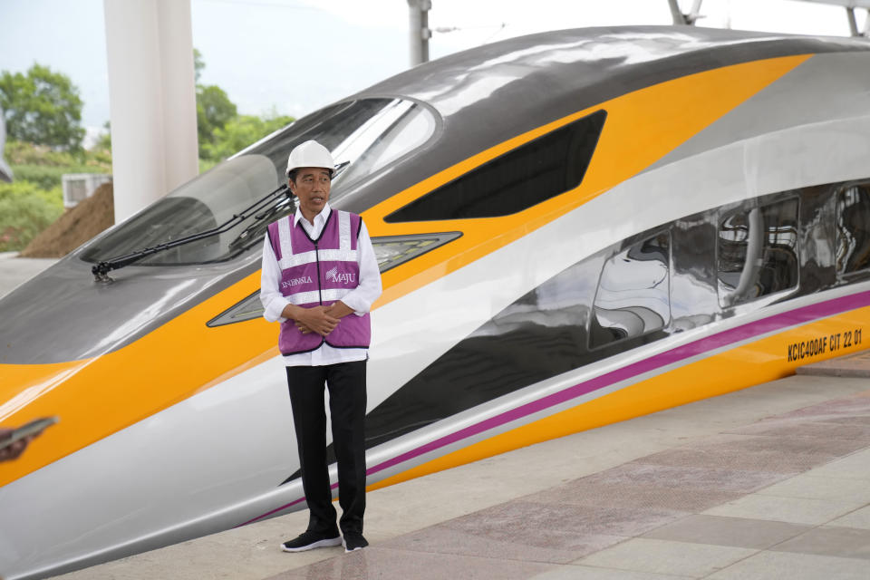 Indonesian President Joko Widodo stands near a newly-unveiled Comprehensive Inspection Train (CIT) unit during his visit at the Jakarta-Bandung Fast Railway station in Tegalluar, West Java, Indonesia, Thursday, Oct. 13, 2022. The 142-kilometer (88-mile) high-speed railway worth $5.5 billion is being constructed by PT Kereta Cepat Indonesia-China, a joint venture between an Indonesian consortium of four state-owned companies and China Railway International Co. Ltd. The joint venture says the trains that will be the fastest in Southeast Asia. (AP Photo/Dita Alangkara)