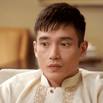 Manny Jacinto raises his eyebrows and makes a face on The Good Place