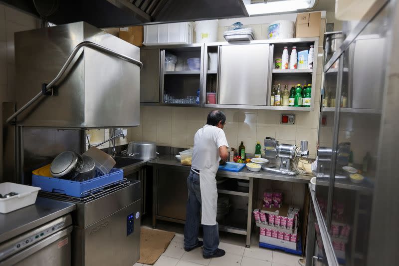 Migrants at work in the kitchen of a Milan restaurant