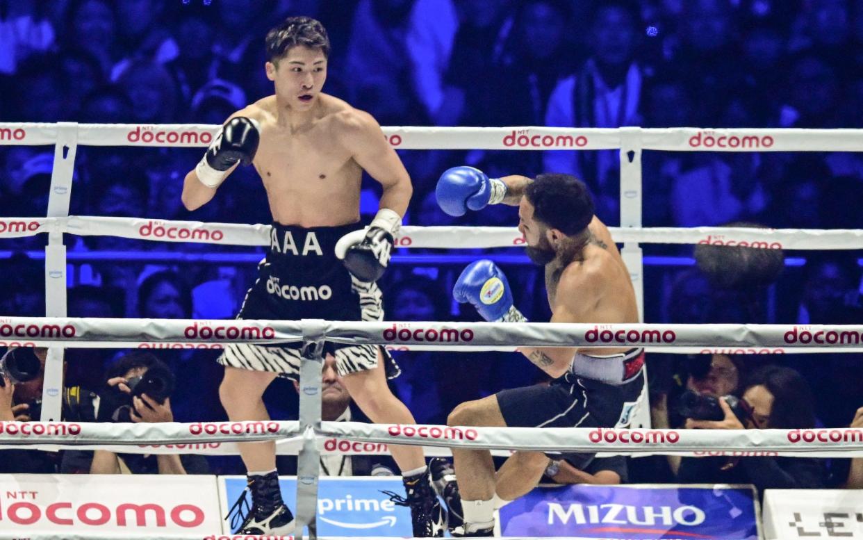 Japan's Naoya Inoue (L) knocks down Mexico's Luis Nery during their IBF-WBA-WBC-WBO super-bantamweight title boxing match