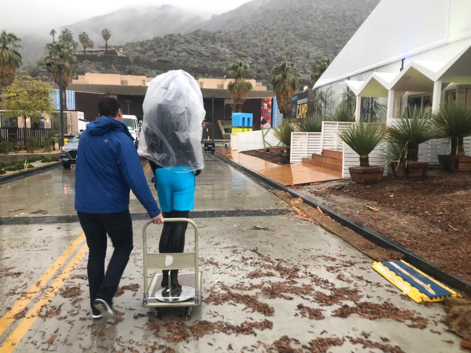 A Modernism Week crew member continues to prep for the opening of the event's CAMP headquarters despite Thursday's rain, Feb. 14, 2019.