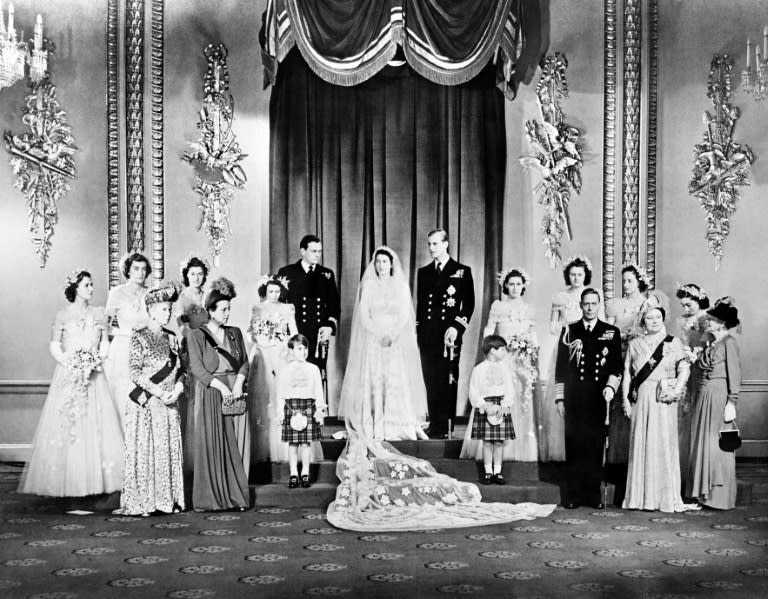 This file photo taken on November 20, 1947 shows Princess Elizabeth (Queen Elizabeth II) and Philip the Duke of Edinburgh on their wedding day in the Throne Room at Buckingham Palace